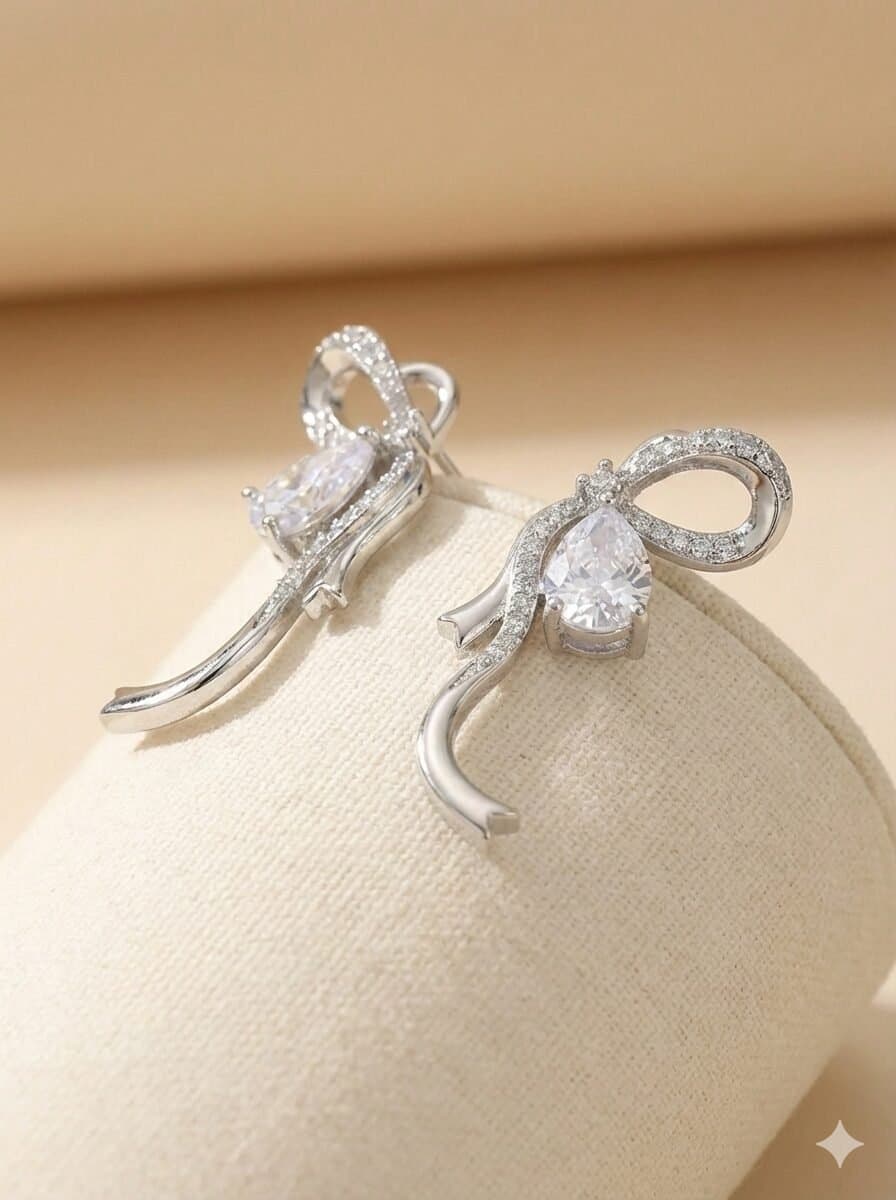 Silver-Toned Pave Ribbon Bow Stud Earrings with Pear-Cut Stone Accent — image 1