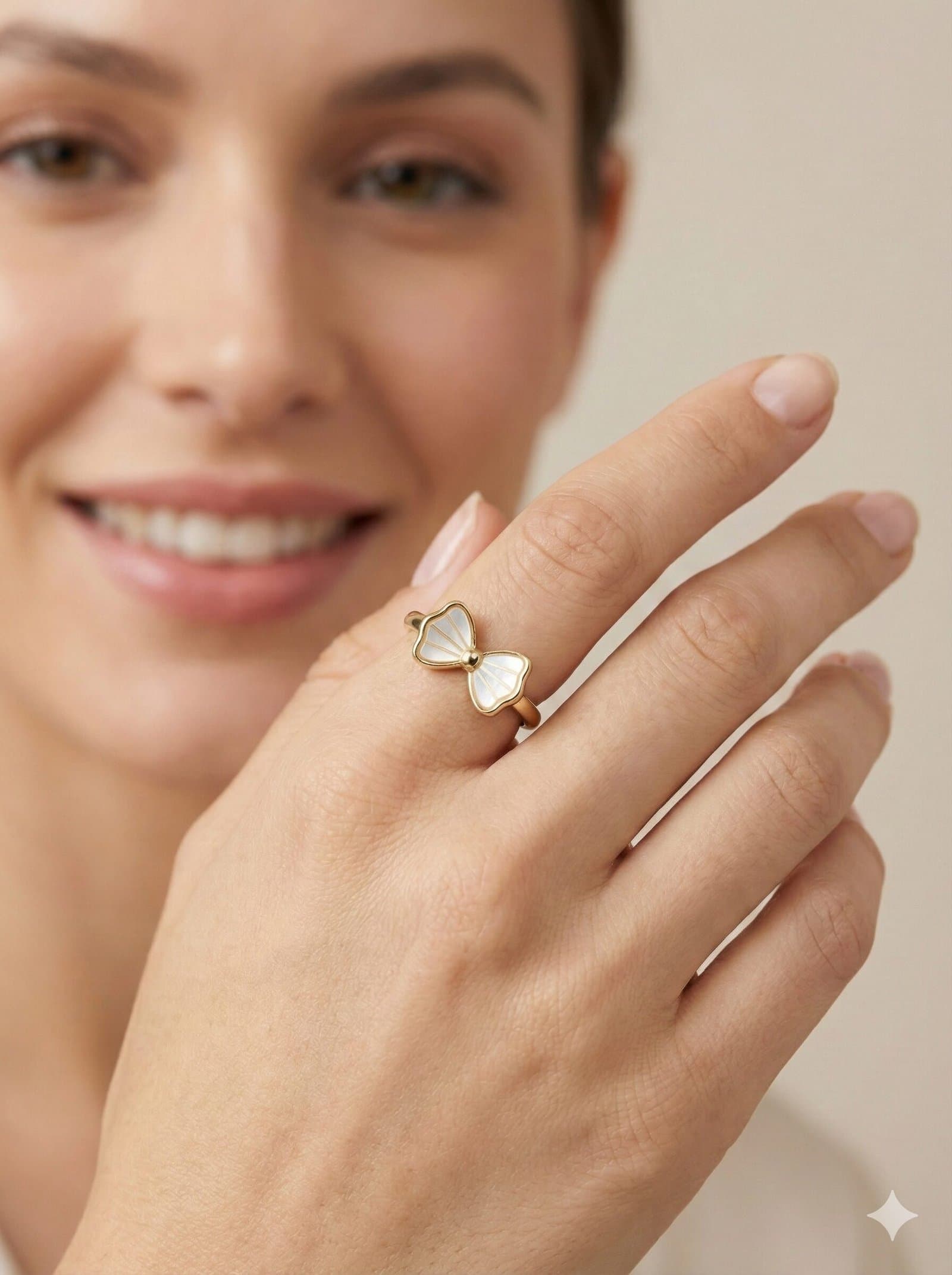 Elegant Gold-Tone Bow Ring with White Pearlescent Inlay and Radial Detailing — image 2