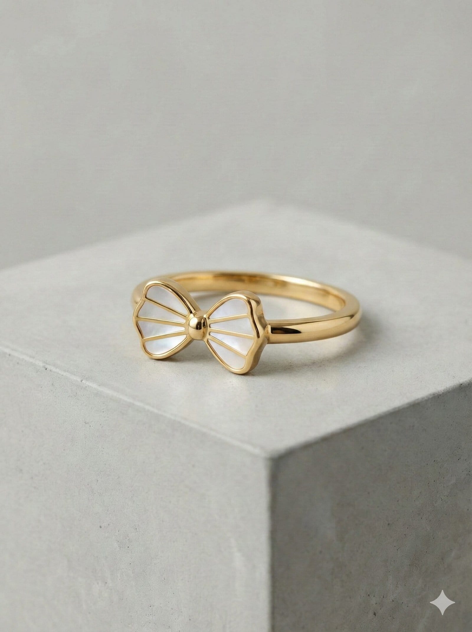 Elegant Gold-Tone Bow Ring with White Pearlescent Inlay and Radial Detailing