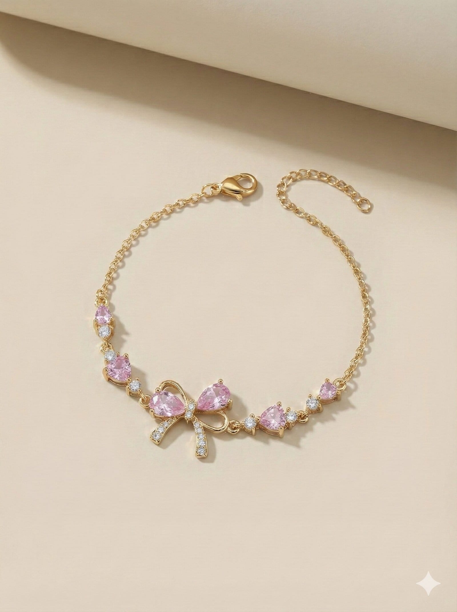 Gold-Tone Adjustable Chain Bracelet with Pink Teardrop Stones and Pave-Style Bow Charm